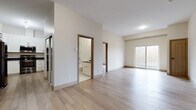 Located at 847 Development Dr in Kingston, Ontario, this well-appointed 2-bedroom, 2-bathroom unit offers a thoughtfully designed single-floor layout filled with contemporary finishes throughout. Light-toned hardwood flooring flows seamlessly across the open-concept living and dining area, creating a bright and cohesive atmosphere. Large sliding glass doors lead to a private balcony, allowing natural light to pour in and offering pleasant views of the surrounding landscape.

The kitchen is efficiently designed with crisp white shaker-style cabinetry, dark countertops, and a full suite of stainless steel appliances, including a refrigerator, range, and over-the-range microwave. A mirrored closet near the kitchen entry adds a practical touch and enhances the sense of space.

Both bedrooms are generously sized with neutral walls and continued hardwood flooring, each featuring windows that invite natural light. The primary bedroom includes access to a well-organized walk-in closet. The two bathrooms are finished with striking marble-style tile on both the floors and shower surround, complemented by dark-topped vanities with undermount sinks. An in-unit laundry area adds everyday convenience. The overall ambiance is clean, modern, and move-in ready.