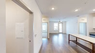 Located at 1290 Kendall Town Blvd in Jacksonville, FL, this single-story 2-bedroom, 2-bathroom home offers a clean, modern aesthetic with thoughtful finishes throughout. The open-concept kitchen and living area serves as the heart of the home, featuring white shaker cabinets, granite countertops, a subway tile backsplash, and a full suite of stainless steel appliances including a refrigerator, range, and microwave. Light wood-style flooring runs through the main living areas, complementing the bright, neutral color palette. The living room benefits from natural light and a ceiling fan, with a glass door providing outdoor access and neighborhood views. The spacious primary bedroom is carpeted for comfort, features its own ceiling fan, and connects to a walk-in closet with built-in shelving and a private en-suite bathroom. The second bedroom is similarly appointed with plush carpet and a ceiling fan. Both bathrooms are finished with wood-look flooring, and one includes a tiled tub-shower combo with brushed nickel grab bars. A dedicated laundry room houses a full-size washer and dryer. The home's efficient, single-floor layout makes for easy living in a well-appointed space.