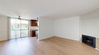 Located in the heart of Hollywood at 1321 N Las Palmas Ave, this one-bedroom, one-bathroom unit offers a well-organized, single-floor layout that makes efficient use of its space. The open living area is bright and welcoming, featuring light hardwood-style flooring, crisp white walls with a subtle chair rail detail, and a ceiling fan that enhances airflow. A standout fireplace adds warmth and character to the living space, while a sliding glass door opens to a private balcony, inviting natural light and outdoor views into the home. The galley-style kitchen is thoughtfully appointed with rich dark wood cabinetry, granite countertops, a stainless steel gas range, dishwasher, and hardwood-style flooring that ties seamlessly into the living area. The bedroom offers a comfortable retreat with plush wall-to-wall carpeting, a large mirrored sliding closet, and a window that fills the room with natural light. The bathroom is clean and functional, featuring a granite-topped vanity with white cabinetry, a full bathtub with shower, and coordinating light wood flooring. The overall aesthetic is clean, neutral, and move-in ready, making this Hollywood unit an excellent urban residence.