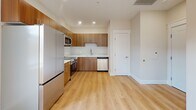 Located at 4 Sullivan St, Unit 301 in Cazenovia, NY, this one-bedroom, one-bathroom residence offers a well-organized, single-floor layout with a clean, modern aesthetic. Light-toned hardwood flooring runs throughout the unit, complementing the neutral warm-white walls and creating a bright, cohesive feel across all rooms.

The kitchen is thoughtfully designed with warm wood cabinetry, stainless steel appliances including a refrigerator, range, microwave, and dishwasher, as well as a subtle tile backsplash and light countertops. Recessed lighting illuminates the space efficiently, and the open layout allows the kitchen to flow naturally into the living area.

The living area is filled with natural light from multiple windows and benefits from recessed ceiling fixtures, offering a versatile and airy atmosphere. The bedroom is a comfortable, well-proportioned room featuring the same hardwood flooring, recessed lighting, and a full-panel double closet for ample storage.

The bathroom is finished with crisp white tile surrounding a full soaking tub with a shower, polished chrome fixtures, and a clean, minimalist design. Throughout the unit, consistent trim work, neutral tones, and quality finishes contribute to a polished and inviting living environment.