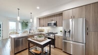 This thoughtfully laid-out one-bedroom, one-bathroom residence in San Diego, CA offers a cohesive coastal aesthetic defined by light wood flooring, crisp white walls, and natural textures throughout. The open-concept kitchen and living area serves as the heart of the home, where a sleek kitchen impresses with warm wood cabinetry, a white quartz waterfall island with an undermount sink, subway tile backsplash, and stainless steel appliances including a gas range. Pendant lighting and recessed fixtures illuminate the space effectively. The living area is bright and airy, benefiting from large windows that draw in natural light, creating a calm, inviting atmosphere. A private balcony extends the living space outdoors, accessible through a glass-paneled door. The bedroom is comfortably sized, featuring large sliding windows with outdoor views, soft carpeting, a barn-style closet door, and ample natural light. The bathroom continues the neutral palette with warm wood vanity cabinetry, a tub-shower combination with white tile surround, and light wood flooring. A hallway connects the rooms efficiently, completing this well-organized San Diego residence.