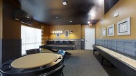 This dedicated game room is thoughtfully designed to provide an engaging recreational space for socializing and entertainment. The room's distinctive aesthetic is defined by warm golden-yellow walls paired with classic gray wainscoting panels, creating a refined yet inviting atmosphere. A bold, dark-painted ceiling adds a dramatic contrast that draws the eye upward, while recessed lighting and an elegant chandelier with exposed Edison-style bulbs provide warm, well-distributed illumination throughout the space.

The room is well-equipped for a variety of tabletop games. A central circular poker table with surrounding chairs serves as a focal point for card game enthusiasts. A full-size billiards table anchors the back of the room, complemented by overhead pendant lighting perfectly positioned for gameplay. Along the far wall, a shuffleboard table offers additional entertainment options. Plush carpeted flooring provides comfort underfoot while helping to define the social and gaming zones within the room.

Natural light filters in through a window dressed with plaid curtains, adding a touch of warmth to the space. Framed artwork and wall accents contribute to the room's polished, club-like character, making it a welcoming destination for friendly competition and leisure.