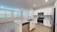 This well-appointed one-bedroom, one-bathroom residence in San Antonio, TX offers a thoughtfully designed layout with modern finishes throughout. Light-toned wood-look flooring runs consistently across the entire space, lending a cohesive and contemporary feel.

The open-concept kitchen and living area serves as the heart of the home. The kitchen is outfitted with crisp white shaker cabinetry, subway tile backsplash, granite countertops, and a full suite of stainless steel appliances, including a French door refrigerator, electric range, built-in microwave, and dishwasher. A center island with an undermount sink and additional seating space anchors the kitchen and opens directly to the living area, which features a ceiling fan and a window allowing natural light.

The bedroom is a comfortable, well-proportioned retreat with two windows, a ceiling fan, and access to a dedicated closet. An in-unit laundry area with a full-size washer and dryer adds everyday convenience.

The bathroom features a granite-topped vanity with white cabinetry and a tub/shower combination clad in striking marble-look tile, creating an elevated and spa-like atmosphere. Neutral wall tones and recessed lighting throughout complete the clean, move-in-ready aesthetic.