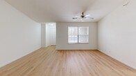 Located on Frostwood Parkway in Peoria, Illinois, this single-floor, two-bedroom, two-bathroom home offers a thoughtfully arranged layout with a clean, neutral aesthetic throughout. The open living area welcomes you with light hardwood flooring, bright white walls, and a ceiling fan that adds both function and style. Natural light filters in through windows fitted with blinds, creating a warm and inviting atmosphere.

The kitchen is a functional centerpiece, featuring rich cherry-toned cabinetry, granite-style countertops, recessed lighting, and a full suite of black and stainless steel appliances including a refrigerator, electric range, microwave, and dishwasher. Neutral tile flooring completes the space. An adjacent utility area conveniently houses a full-size washer and dryer.

The primary bedroom is generously sized, offering plush carpeting, a ceiling fan, a large window with outdoor views, and a mirrored sliding-door closet. The second bedroom also features carpet, a ceiling fan, and a bright window. Both rooms are comfortable and well-proportioned.

The two bathrooms are finished in crisp white tones — one features a soaking tub and shower combo with tile flooring, while the other offers a dedicated walk-in shower stall. A dedicated closet provides additional storage. This home combines practicality with comfortable, move-in-ready living.