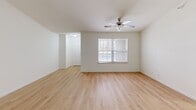 Located on Frostwood Parkway in Peoria, Illinois, this single-floor, two-bedroom, two-bathroom home offers a thoughtfully arranged layout with a clean, neutral aesthetic throughout. The open living area welcomes you with light hardwood flooring, bright white walls, and a ceiling fan that adds both function and style. Natural light filters in through windows fitted with blinds, creating a warm and inviting atmosphere.

The kitchen is a functional centerpiece, featuring rich cherry-toned cabinetry, granite-style countertops, recessed lighting, and a full suite of black and stainless steel appliances including a refrigerator, electric range, microwave, and dishwasher. Neutral tile flooring completes the space. An adjacent utility area conveniently houses a full-size washer and dryer.

The primary bedroom is generously sized, offering plush carpeting, a ceiling fan, a large window with outdoor views, and a mirrored sliding-door closet. The second bedroom also features carpet, a ceiling fan, and a bright window. Both rooms are comfortable and well-proportioned.

The two bathrooms are finished in crisp white tones — one features a soaking tub and shower combo with tile flooring, while the other offers a dedicated walk-in shower stall. A dedicated closet provides additional storage. This home combines practicality with comfortable, move-in-ready living.