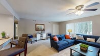 This single-floor residence offers a functional and comfortable layout across two bedrooms and two bathrooms. The open living room is a welcoming centerpiece, featuring plush carpeting, a ceiling fan, and a large window dressed with vertical blinds that fills the space with natural light and provides views of surrounding greenery. A louvered closet adds convenient built-in storage to the living area.

The kitchen is efficiently designed with white cabinetry, light countertops, a stainless steel sink, and tile flooring. A pass-through counter enhances the connection between the kitchen and the adjacent hallway, which leads seamlessly to the rest of the residence.

The primary bedroom is generously sized, offering carpet flooring, a ceiling fan, a large window, and a louvered double closet. The second bedroom is cozily appointed with carpet flooring, a built-in closet with a hanging rod, and a warm, neutral color palette. A dedicated walk-in closet with full-width shelving and hanging rods provides ample additional storage.

Both bathrooms are cleanly finished with vanity cabinetry, mirrored medicine cabinets, and light fixtures overhead. The neutral tones throughout the residence create a calm, cohesive ambiance suited for everyday living.