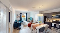 This well-designed single-floor residence at 13735 SW 262nd St in Homestead, Florida, presents a thoughtfully planned layout that balances comfort and functionality. The open-concept living and dining area serves as the heart of the home, featuring light wood-style flooring, crisp white walls, and a seamless flow between spaces. A sliding glass door brings in natural light and provides access to an outdoor balcony, enhancing the airy atmosphere of the living area. The kitchen is outfitted with dark espresso cabinetry, stainless steel appliances, granite countertops, and a matching granite backsplash, offering both style and practicality. The bedrooms are bright and inviting, with large windows dressed in elegant curtains that allow ample natural light. The primary bedroom includes direct access to an en-suite bathroom, while a secondary bedroom provides equal comfort and accessibility. Both bathrooms feature tiled tub-shower combinations with clean, neutral finishes and dark wood vanities with granite countertops. Throughout the residence, light wood-style flooring, neutral tones, and modern fixtures create a cohesive and welcoming aesthetic suited for everyday living in Homestead, FL.