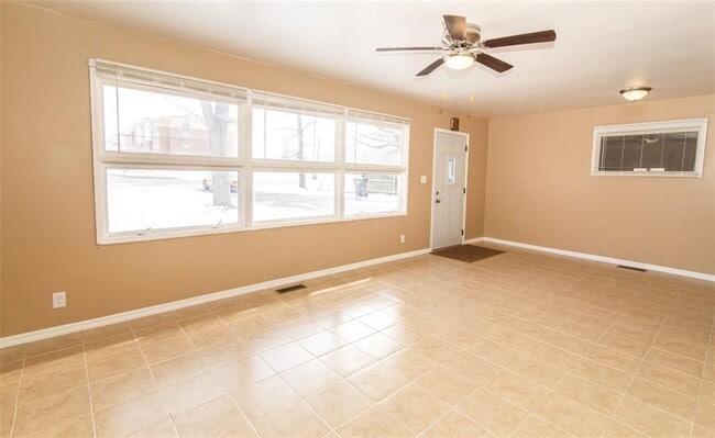 Living room boasts lots of natural light, an updated ceiling fan and easy maintenance tile flooring. - 2950 N Ritter Ave