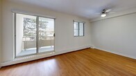 Located at 5611 Valley Way in Niagara Falls, Ontario, this one-bedroom, one-bathroom unit offers a practical and comfortable layout spread across a single floor. Warm hardwood-style flooring runs throughout the entire space, lending a cohesive and inviting feel to every room.

The living room is bright and open, benefiting from large sliding glass doors that lead to one of two balconies, allowing for an abundance of natural light and pleasant outdoor views of surrounding greenery. A ceiling fan adds to the comfort of the space. The adjacent dining area provides a natural flow for everyday living and entertaining.

The kitchen is well-appointed with ample white cabinetry extending to the ceiling, generous grey countertop surfaces, a stainless steel refrigerator, and a double sink — offering both functionality and storage. The layout makes efficient use of the space with counters on both sides.

The bedroom is a comfortable size, featuring a large sliding-door closet, a window with natural light and tree views, and a baseboard heating system. Additional closet space is available elsewhere in the unit, providing excellent storage options.

The bathroom is clean and modern, featuring a sliding glass-enclosed shower, a white vanity with under-sink storage, and consistent hardwood-style flooring. The unit is completed by a welcoming entrance that connects all areas efficiently.