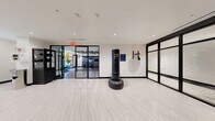 This 1,760 square foot fitness facility in Bethesda, MD, offers a comprehensive workout experience within a single-floor layout. The space boasts a striking blend of modern design and functionality, featuring high ceilings with decorative panels and strategic lighting that creates an inviting atmosphere.

The main workout area is equipped with a range of cardio machines, including multiple treadmills and stationary bikes, all facing large windows that provide natural light and outdoor views. Adjacent to this is a strength training section with free weights and resistance machines.

Glass partitions divide the space into distinct zones while maintaining an open feel. A separate area houses additional equipment and colorful exercise balls, adding a vibrant touch to the environment. The facility also includes a specialized section, possibly for group classes or personal training, with wood-look flooring and mirrored walls.

Throughout the space, the flooring transitions from wood-look to more functional surfaces, accommodating different exercise needs. Thoughtful details such as water stations, towel services, and storage solutions are integrated seamlessly.

The facility's design prioritizes both aesthetics and practicality, creating an environment that's not only conducive to effective workouts but also visually appealing and motivating for users of all fitness levels.