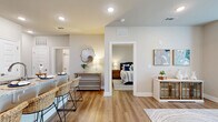 Located at 8890 Ransley Station Blvd in Pensacola, FL, this single-story, one-bedroom, one-bathroom unit offers a thoughtfully designed layout making efficient use of its cozy footprint. Light wood-style flooring runs throughout, tying each space together in a clean, cohesive aesthetic.

The open-concept kitchen is a standout feature, equipped with stainless steel appliances—including a refrigerator, range, and over-the-range microwave—complemented by white shaker cabinetry, a light blue subway tile backsplash, and granite countertops. A peninsula with bar seating extends the prep and dining space, making it ideal for casual meals.

The living room receives ample natural light through large windows dressed with sheer curtains, and is finished with recessed lighting and a ceiling fan. The space offers a comfortable and airy atmosphere well-suited for relaxing or entertaining.

The bedroom is a serene retreat, featuring a ceiling fan, a window with exterior views, and direct access to a dedicated walk-in closet with built-in shelving. The bathroom is clean and functional, featuring a granite-topped vanity with white cabinetry, a full tub-shower combo, and wood-style flooring. A hallway connects the rooms, contributing to a smooth and logical flow throughout the unit.