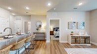 Located at 8890 Ransley Station Blvd in Pensacola, FL, this single-story, one-bedroom, one-bathroom unit offers a thoughtfully designed layout making efficient use of its cozy footprint. Light wood-style flooring runs throughout, tying each space together in a clean, cohesive aesthetic.

The open-concept kitchen is a standout feature, equipped with stainless steel appliances—including a refrigerator, range, and over-the-range microwave—complemented by white shaker cabinetry, a light blue subway tile backsplash, and granite countertops. A peninsula with bar seating extends the prep and dining space, making it ideal for casual meals.

The living room receives ample natural light through large windows dressed with sheer curtains, and is finished with recessed lighting and a ceiling fan. The space offers a comfortable and airy atmosphere well-suited for relaxing or entertaining.

The bedroom is a serene retreat, featuring a ceiling fan, a window with exterior views, and direct access to a dedicated walk-in closet with built-in shelving. The bathroom is clean and functional, featuring a granite-topped vanity with white cabinetry, a full tub-shower combo, and wood-style flooring. A hallway connects the rooms, contributing to a smooth and logical flow throughout the unit.