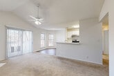 Located at 6609 Reafield Dr in Charlotte, NC, this two-bedroom, two-bathroom home offers a well-designed single-floor layout with a bright, open feel. The living room is a standout space, featuring vaulted ceilings, a ceiling fan, a wood-burning fireplace, and a sliding glass door that fills the room with natural light and provides outdoor access. Plush carpeting runs throughout the living areas and bedrooms, adding warmth and comfort.

The kitchen is designed for functionality, featuring white cabinetry, a tile backsplash, wood-look flooring, and black appliances including a range, refrigerator, and dishwasher. A peninsula with a pass-through connects the kitchen to the living area, creating an open and social atmosphere.

Both bedrooms are carpeted and well-lit with multiple windows that allow natural light to pour in. The primary bedroom is generously sized with ample closet space. Each bedroom is served by its own bathroom. The bathrooms feature white vanities with generous counter space, large mirrors, wood-look tile flooring, and tiled tub-shower combinations. A hallway and two closets complete the practical layout, offering convenient storage throughout the home.