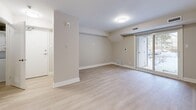 This single-floor, 3-bedroom, 2-bathroom residence offers a thoughtfully organized layout that maximizes functionality across its living spaces. Light-toned laminate flooring runs consistently throughout, creating a cohesive and clean aesthetic from room to room.

The open living area features neutral warm-grey walls, white baseboards, and a sliding glass door that brings in natural light and provides outdoor views. A dedicated hallway connects the living zone to the private bedrooms, offering a clear and practical flow through the home.

The kitchen is outfitted with sleek, high-gloss white cabinetry that extends to the ceiling for ample storage, complemented by light stone countertops and a full suite of stainless steel appliances, including a refrigerator, dishwasher, and range. The space is clean, bright, and efficient in its design.

The primary bedroom offers a comfortable footprint with direct access to adjoining rooms, while the two additional bedrooms are well-proportioned and versatile. One bedroom features a window with views to the surrounding neighbourhood, allowing for natural light.

Both bathrooms are finished in a contemporary style, featuring white vanities with stone-look countertops, mirrored medicine cabinets, and clean fixtures. One bathroom includes a full soaker tub with a bright white surround. A dedicated laundry area and closet round out this practical and well-appointed home.