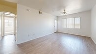 Located at 1333 N 24th St in Phoenix, AZ, this single-floor unit offers three bedrooms and two bathrooms within a well-organized and functional layout. The open living room features light wood-style flooring, a ceiling fan, and a large window with vertical blinds that allow ample natural light to fill the space. The kitchen is equipped with light wood cabinetry, a full suite of white appliances including a refrigerator, electric range, and built-in microwave, along with dark countertops and a double-basin sink. Each bedroom is carpeted and features a ceiling fan and windows with vertical blinds, providing comfortable, light-filled spaces. The primary bedroom is generously sized and includes a mirrored sliding closet. Both bathrooms offer clean, white tub-shower combinations with wood-style flooring and vanities with countertop sinks. A dedicated laundry room includes built-in shelving and an in-unit washer, adding everyday convenience. The unit's neutral color palette, consistent finishes, and practical layout create a cohesive and comfortable living environment throughout.
