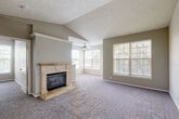 Located at 4237 S 147th Plaza in Omaha, Nebraska, this well-appointed 2-bedroom, 2-bathroom residence offers a thoughtfully designed single-floor layout. The living room serves as the heart of the home, showcasing vaulted ceilings, a ceiling fan, a classic tile-surround fireplace with a wood mantel, and an abundance of natural light streaming through multiple large windows with views of surrounding greenery.

The kitchen features white cabinetry with wood trim accents, generous counter space, tile flooring, a dishwasher, and a window that brings in additional natural light. It opens conveniently toward the living area, creating an easy flow for daily living.

Both bedrooms are carpeted and well-sized, with ample natural light from sizable windows. The primary bedroom includes a dedicated closet with built-in shelving. The bathrooms are clean and functional, with one featuring a soaking tub set within a tiled surround.

A dedicated laundry room provides added convenience, housing a full-size washer and dryer with overhead shelving for storage. The hallway connects the rooms efficiently, with closets offering additional storage. Neutral tones and textured ceilings throughout lend the space a warm, cohesive feel.