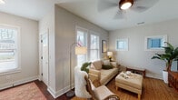 Located at 712 Lynn St in Louisville, Kentucky, this well-designed two-story home offers a thoughtful layout with stylish finishes across both levels. The main floor welcomes you into a comfortable living room featuring dark hardwood floors, vaulted ceilings, a ceiling fan, and multiple windows that fill the space with natural light. Adjacent to the living area, the dining room showcases the same rich hardwood flooring, large windows with blinds, and a pendant light fixture, creating an inviting space for gatherings. The kitchen is well-equipped with warm wood cabinetry, granite countertops, stainless steel appliances, a tile backsplash, and a window over the sink. A convenient half bath on the main floor features light hardwood flooring, a pedestal sink, and a round mirror with industrial-style lighting. Upstairs, the spacious primary bedroom offers plush carpeting, a ceiling fan, multiple windows, and access to a private en-suite bathroom with a granite-topped vanity and warm wood cabinetry. An additional upper-level room features carpet, multiple windows, and unique pendant lighting, making it a versatile space. A skylight brightens the stairwell, adding an airy quality to the transition between floors. Throughout the home, neutral tones and clean architectural lines create a cohesive and inviting atmosphere.