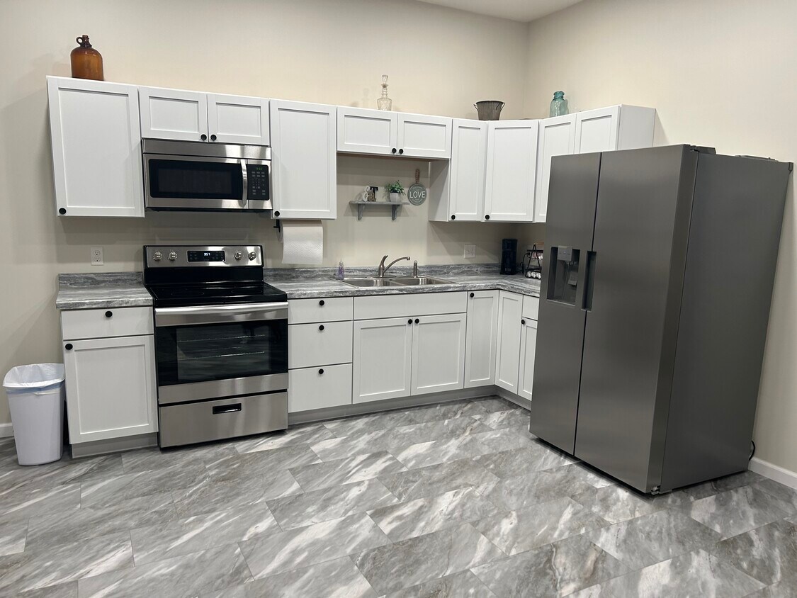 Fully furnished kitchen with microwave, stove, fridge - 812 Commercial St