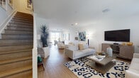 Located at 11720 SW 43rd St in Miramar, Florida, this two-story home offers a well-designed layout with a bright, contemporary aesthetic throughout. The main level centers around an expansive open-concept living and dining area, where wood-look flooring, crisp white walls, and abundant natural light from large windows create an inviting atmosphere. The living space is generously proportioned, accommodating multiple seating arrangements, including a lounge area with modern accent chairs positioned beneath a curated gallery wall.

The kitchen is a standout feature, outfitted with white cabinetry, granite countertops, stainless steel appliances, and a large island with bar seating. Pendant lighting and track lighting add a polished touch, while an adjacent window and glass door bring in outdoor views and natural light.

Upstairs, the bedrooms offer a peaceful retreat. The primary bedroom features a walk-in closet, ceiling fan, and soft neutral tones, while an additional bedroom benefits from multiple windows and natural light. Bathrooms on both levels include granite-topped vanities and light wood cabinetry, with one bathroom featuring a glass-enclosed shower and another offering a shower-tub combination, completing this well-appointed home.