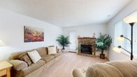 Located at 3432 Norfeld Ct in Virginia Beach, Virginia, this single-floor home offers a comfortable and functional layout spread across several well-defined living spaces. The living room serves as the heart of the home, featuring wall-to-wall carpeting, a textured ceiling, and a classic brick wood-burning fireplace flanked by a exterior door that brings in natural light. The space is generously proportioned, accommodating multiple seating areas with ease.

The galley-style kitchen is efficiently designed with warm wood cabinetry, granite-look countertops, tile flooring, and a full suite of stainless steel appliances including a refrigerator, electric range, microwave, and dishwasher. A window above the sink area adds natural brightness.

The dining area sits adjacent to the kitchen and features tile flooring and a ceiling fan overhead, creating a practical and comfortable space for meals.

The bedroom is carpeted and well-lit, with a textured ceiling and a window allowing natural light. Built-in closet shelving and additional storage closets provide practical organization options throughout.

A bathroom with tile flooring and a wood-toned vanity connects conveniently to the bedroom. A dedicated laundry room with side-by-side washer and dryer and wire shelving above rounds out the home's practical amenities.