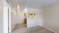 Located at 1629 W Thornhill Dr in Taylorsville, Utah, this one-bedroom, one-bathroom unit offers a practical and well-organized single-floor layout. The entry foyer features wood-look vinyl flooring that transitions seamlessly into the combined living, dining, and kitchen area. The living space is brightened by natural light from window blinds and includes a ceiling fan overhead, contributing to a comfortable atmosphere.

The kitchen is defined by warm-toned wood cabinetry, granite-patterned countertops, and a pass-through window that connects to the dining and living areas, creating an open and communicative flow. White appliances, including a coil-top electric range and refrigerator, are neatly integrated into the kitchen layout, which also features a built-in range hood.

The bedroom is a carpeted, sun-filled retreat with a window fitted with horizontal blinds that allow for adjustable natural light. A dedicated closet provides convenient built-in storage, while an adjacent door leads directly to the full bathroom, which includes a shower-tub combination and wood-look flooring.

Neutral wall tones and clean white trim throughout the unit create a cohesive, understated aesthetic that is both functional and easy to personalize.