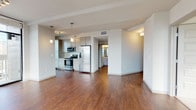 Located at 1215 Elati St in Denver's dynamic Golden Triangle neighborhood, this modern urban residence offers a well-appointed single-floor layout with refined contemporary finishes throughout. Rich hardwood flooring flows through the open-concept living and dining areas, which are anchored by large floor-to-ceiling glass doors and windows that frame stunning panoramic views of the Denver skyline. A ceiling fan and pendant lighting add functional style to the living space, which opens directly to a private balcony. The galley-style kitchen is outfitted with stainless steel appliances, granite countertops, custom grey cabinetry, subway tile backsplash, and a dramatic floor-to-ceiling window that fills the space with natural light and city views. The primary bedroom features plush carpet, oversized windows with sweeping urban vistas, and access to a well-organized walk-in closet. An en-suite bathroom includes granite countertops, dark wood cabinetry, and hardwood flooring. A secondary bedroom with soft carpet and ample natural light provides flexibility for guests or a home office. A full bathroom with white subway tile, a soaking tub, and chrome fixtures completes this thoughtfully designed urban residence.