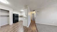 Located in Schertz, TX, this single-story, three-bedroom, two-bathroom home offers a practical and comfortable layout. The kitchen is a standout feature, designed in a U-shape with ample white cabinetry, granite-style countertops, a double-basin sink, and durable wood-style flooring. It is equipped with a black refrigerator and an electric range, with a convenient closet adjacent to the kitchen providing additional storage. The kitchen opens toward a hallway that connects the living areas to the bedrooms, creating a cohesive flow throughout the home. The three bedrooms are finished with soft, neutral carpet and feature individual closets with built-in rods for organized storage. Two of the bedrooms include windows fitted with blinds, allowing for natural light while maintaining privacy. The textured ceilings are consistent throughout the home, contributing to a classic residential aesthetic. The two bathrooms are finished with wood-style flooring and feature granite-style countertops with white cabinetry. One bathroom includes a full tiled tub-and-shower combination, while the other offers a more compact design. The neutral color palette throughout the home creates a clean, move-in-ready atmosphere well-suited for a variety of lifestyles.