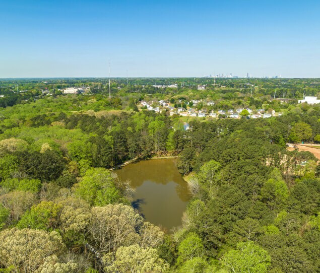 An aerial view of the City of Atlanta over a small lake in Panthersville.