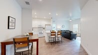 Located at 2089 Heritage Key Blvd in Kissimmee, FL, this well-designed 2-bedroom, 3-bathroom single-floor residence offers a bright and functional layout with a clean, modern aesthetic throughout. The open-concept living area seamlessly connects the kitchen, dining, and living spaces, creating a welcoming and versatile environment. Wood-look flooring runs throughout the main living areas, complementing the crisp white walls and recessed lighting overhead.

The kitchen is well-appointed with white shaker cabinetry, light quartz countertops, a full suite of white appliances including a refrigerator, range, microwave, and dishwasher, and a central island with bar seating. The adjacent dining area provides additional seating, while the living room features a ceiling fan and large windows and a glass door that invite natural light and outdoor views.

Both bedrooms are carpeted and comfortably sized, with the primary bedroom offering dual windows with neighborhood views and a ceiling fan. Each bedroom benefits from its own closet. The three bathrooms are finished with white cabinetry, quartz-topped vanities, and tub-shower combinations, maintaining the home's consistent, light-filled aesthetic. A hallway connects all rooms efficiently, contributing to the space's practical and cohesive flow.