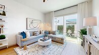 Located at 250 W Combs Road in Queen Creek, Arizona, this thoughtfully designed one-bedroom, one-bathroom residence offers a bright and cohesive living experience across a single floor. Light wood flooring flows throughout, complementing a crisp white palette that enhances the sense of openness in every room.

The combined kitchen and living area forms the heart of the home. The galley-style kitchen is outfitted with two-tone gray and white shaker cabinetry, white quartz countertops, stainless steel appliances including a French door refrigerator and dishwasher, and a window above the sink that fills the space with natural light. An open floating shelf adds a stylish, functional touch.

The living room is bright and airy, anchored by large sliding glass doors that open to a private outdoor patio with greenery — seamlessly connecting indoor and outdoor living. A wide entryway with warm wood flooring and clean white walls provides a welcoming transition into the home.

The bedroom is a calm, neutral retreat featuring natural light from shuttered windows, carpet flooring, and a dedicated closet. The full bathroom offers a frameless glass walk-in shower, a single-sink vanity with white cabinetry and matte black hardware, and wood-look flooring, combining clean design with everyday functionality.
