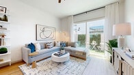 Located at 250 W Combs Road in Queen Creek, Arizona, this thoughtfully designed one-bedroom, one-bathroom residence offers a bright and cohesive living experience across a single floor. Light wood flooring flows throughout, complementing a crisp white palette that enhances the sense of openness in every room.

The combined kitchen and living area forms the heart of the home. The galley-style kitchen is outfitted with two-tone gray and white shaker cabinetry, white quartz countertops, stainless steel appliances including a French door refrigerator and dishwasher, and a window above the sink that fills the space with natural light. An open floating shelf adds a stylish, functional touch.

The living room is bright and airy, anchored by large sliding glass doors that open to a private outdoor patio with greenery — seamlessly connecting indoor and outdoor living. A wide entryway with warm wood flooring and clean white walls provides a welcoming transition into the home.

The bedroom is a calm, neutral retreat featuring natural light from shuttered windows, carpet flooring, and a dedicated closet. The full bathroom offers a frameless glass walk-in shower, a single-sink vanity with white cabinetry and matte black hardware, and wood-look flooring, combining clean design with everyday functionality.