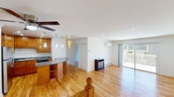 Located at 7940 Janes Ave in Woodridge, IL, this well-appointed single-floor home offers three bedrooms and two bathrooms across a thoughtfully designed layout. Warm hardwood floors run throughout, creating a cohesive and inviting atmosphere.

The open-concept kitchen and living area serves as the heart of the home. The kitchen is equipped with rich wood cabinetry, granite countertops, stainless steel appliances, and a peninsula with additional storage. The living room is bright and airy, featuring recessed lighting, a ceiling fan, a wall-mounted HVAC unit, and a sliding glass door that opens to a private outdoor patio — ideal for natural light and easy outdoor access.

The primary bedroom is generously sized, complete with a ceiling fan, a wall-mounted HVAC unit, a natural window view, and a built-in closet with shelving. The additional bedrooms also feature hardwood floors and well-organized closet systems with shelving and hanging rods.

Both bathrooms have been renovated with a clean, modern aesthetic. The full bath showcases marble-style tile flooring and a tub-shower surround with a decorative mosaic accent border. The second bath features a marble-top vanity and matching tile flooring, conveying a consistent, polished finish throughout.