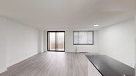 Located at 4921 Seminary Rd in Alexandria, VA, this two-bedroom, one-bathroom unit offers a clean, modern aesthetic throughout. The open-concept living and kitchen area serves as the heart of the home, bathed in natural light from large windows and a sliding glass door that opens onto a private balcony with outdoor views. Light wood-style flooring flows seamlessly across the entire space, complementing the crisp white walls and creating a bright, cohesive atmosphere. The kitchen is efficiently designed with dark granite-style countertops, white shaker cabinetry, a subway tile backsplash, and stainless steel appliances including a gas range and built-in microwave. The spacious primary bedroom features a generous footprint with a window overlooking the surrounding neighborhood, recessed lighting, and a closet. The second bedroom is comfortably sized with its own window and easy hallway access. The full bathroom is finished in clean white tile and includes a tub-shower combination with chrome fixtures. A hallway connects all rooms, providing a practical and well-organized layout. The overall ambiance is contemporary and move-in ready, making this a functional and attractive unit in the Seminary Road corridor of Alexandria.