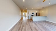 This contemporary single-story home offers 960 square feet of thoughtfully designed living space. The open floor plan seamlessly connects the living room and kitchen, creating an inviting atmosphere for both relaxation and entertainment. The kitchen boasts modern amenities, including stainless steel appliances, granite countertops, and ample cabinet space. Pendant lighting adds a touch of elegance to the space.

The home features two bedrooms, with the primary bedroom measuring a generous 190 square feet. Large windows in each room flood the space with natural light, while ceiling fans provide comfort and air circulation. The bathroom is well-appointed with a sleek vanity and modern fixtures.

Throughout the home, neutral-toned walls and durable wood-look flooring create a cohesive and low-maintenance interior. Recessed lighting and strategically placed windows ensure bright, airy spaces throughout the day. The property's layout maximizes functionality and flow, making it an ideal choice for those seeking a modern, efficient living space in York, PA.