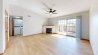 Located at 4020 33rd Ave SW in Cedar Rapids, Iowa, this 2-bedroom, 1-bathroom unit offers a well-designed single-floor layout that maximizes comfort and functionality. The open living room is a standout space, featuring light hardwood flooring, a ceiling fan, vaulted ceilings, a corner fireplace with a clean tile surround, and sliding glass doors that open onto a private balcony, filling the room with natural light. The kitchen is efficiently arranged in an L-shaped layout with warm honey-toned wood cabinetry, light granite-style countertops, a black appliance suite including a gas range, built-in microwave, refrigerator, and dishwasher, all complemented by the same hardwood flooring that flows through the living area. Both bedrooms are carpeted in a neutral gray tone and feature large windows that invite natural light and outdoor views of the surrounding neighborhood. The primary bedroom includes a closet with a warm wood-tone door. The bathroom is clean and practical, offering a full tub-and-shower combo with white surround, black matte fixtures, and a wood-cabinet vanity with a light countertop. Overall, the unit presents a cohesive, move-in-ready aesthetic with consistent warm wood accents throughout.