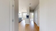 Located at 5033 Old Middleton Rd in Madison, WI, this thoughtfully designed 2-bedroom, 3-bathroom residence offers a clean, contemporary aesthetic throughout its single-floor layout. The open-concept living and kitchen area is a standout, featuring warm hardwood-style flooring, expansive windows that flood the space with natural light, and sweeping outdoor views of the surrounding neighborhood. The kitchen is well-appointed with white shaker cabinetry, granite countertops, stainless steel appliances including a refrigerator, range, and microwave, a deep basin sink, and a large central island with pendant lighting — ideal for both cooking and casual dining. The generous primary bedroom includes plush carpeting, a ceiling fan, and a bright window with tree-lined views. The second bedroom also features hardwood-style flooring and multiple windows offering outdoor sightlines. Each of the three bathrooms is finished with granite-topped vanities, gray cabinetry with matte black hardware, and wood-look flooring. The bathrooms are well-lit and include walk-in showers. Two dedicated closets provide practical storage throughout. Neutral gray walls and white trim tie the modern design together cohesively, creating a bright and welcoming atmosphere throughout the entire residence.