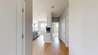 Located at 5033 Old Middleton Rd in Madison, WI, this thoughtfully designed 2-bedroom, 3-bathroom residence offers a clean, contemporary aesthetic throughout its single-floor layout. The open-concept living and kitchen area is a standout, featuring warm hardwood-style flooring, expansive windows that flood the space with natural light, and sweeping outdoor views of the surrounding neighborhood. The kitchen is well-appointed with white shaker cabinetry, granite countertops, stainless steel appliances including a refrigerator, range, and microwave, a deep basin sink, and a large central island with pendant lighting — ideal for both cooking and casual dining. The generous primary bedroom includes plush carpeting, a ceiling fan, and a bright window with tree-lined views. The second bedroom also features hardwood-style flooring and multiple windows offering outdoor sightlines. Each of the three bathrooms is finished with granite-topped vanities, gray cabinetry with matte black hardware, and wood-look flooring. The bathrooms are well-lit and include walk-in showers. Two dedicated closets provide practical storage throughout. Neutral gray walls and white trim tie the modern design together cohesively, creating a bright and welcoming atmosphere throughout the entire residence.