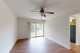 Located at 7 Prism Place in Gaithersburg, MD, this single-floor, 2-bedroom, 2-bathroom residence offers a well-organized layout designed for comfortable everyday living. Warm hardwood-style flooring flows consistently throughout the home, creating a cohesive and inviting atmosphere.

The living room is a bright, open space featuring crown molding, a ceiling fan with light fixture, and sliding glass doors that open to an outdoor view of lush greenery, filling the room with natural light. An adjacent dining room provides a dedicated space for meals, while the kitchen is equipped with wood-toned cabinetry and essential appliances. A pantry and utility room add practical storage and functionality to the home.

The primary bedroom is a generously sized retreat, complete with a large walk-in closet outfitted with wire shelving on multiple walls. The second bedroom, bathed in natural light from a wide window with blinds, offers a clean and versatile space. Both bathrooms are well-appointed, with one featuring warm wood-toned vanity cabinetry, a single-basin sink, and a well-lit mirror. Five closets throughout the home ensure ample storage. In-unit laundry adds convenience, rounding out this well-equipped residence.