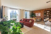 Located at 500 Race St in San Jose, CA, this well-appointed 1-bedroom, 1-bathroom residence offers a thoughtfully designed single-floor layout. The open-concept living and dining area is a true standout, bathed in natural light through large windows dressed with sheer white curtains that frame lush outdoor views. The living room features neutral tones, light tile-style flooring, and a welcoming atmosphere ideal for relaxing or entertaining.

The dining area is anchored by a striking geometric wood-paneled accent wall that adds warmth and visual depth, complemented by track lighting overhead and a large oval dining table with modern seating. The kitchen is well-equipped with rich dark wood cabinetry, granite countertops, stainless steel appliances, warm bamboo-style flooring, and a peninsula with a pendant light — connecting seamlessly to the living and dining spaces.

The bedroom offers a serene retreat with plush carpeting, soft neutral walls, and ample closet space. The bathroom features a clean, bright design with a full soaking tub and shower combo, wood-tone flooring, and white cabinetry. Additional spaces include an entrance, hallway, pantry, and in-unit laundry, making this a complete and functional home.