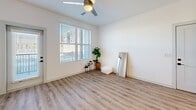 This contemporary 660 square foot apartment in Mesa, Arizona offers a thoughtful blend of style and functionality. The open-concept design seamlessly integrates the living area and kitchen, creating a spacious feel within the compact layout. The kitchen is a standout feature, boasting white cabinetry, stainless steel appliances, and a stylish herringbone backsplash. A central island with pendant lighting serves as both a prep area and casual dining space.

The living room is bathed in natural light from large windows, complemented by warm wood-look flooring throughout. The bedroom, measuring 140 square feet, features plush carpeting and a generous window. A well-appointed bathroom showcases modern fixtures and elegant tile work.

Storage is abundant, with a walk-in closet offering ample space and built-in organizers. The unit's clean lines, neutral color palette, and contemporary fixtures create a cohesive, modern aesthetic. Energy-efficient appliances and a ceiling fan contribute to the apartment's eco-friendly design. Located at 1340 S 48th St in Mesa, this single-floor dwelling combines urban convenience with comfortable living in a compact, well-designed space.