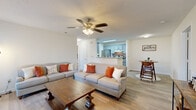 This two-bedroom, two-bathroom single-floor residence in Rock Hill, SC offers a well-designed layout that maximizes functionality and comfort. The open-concept living room is bright and welcoming, featuring wood-look flooring, a ceiling fan with light fixture, and French doors that invite natural light from outside. The space flows seamlessly into a dining area and a galley-style kitchen outfitted with gray shaker cabinetry, granite-style countertops, a mosaic tile backsplash, and stainless steel appliances including a refrigerator and electric range. Both bedrooms are carpeted and receive natural light through windows with blinds. The primary bedroom includes access to a spacious walk-in closet with wire shelving, offering generous storage. A second closet serves the additional bedroom. Each bathroom features gray vanity cabinetry with granite-style countertops, wood-look flooring, and a tub/shower combination. A hallway connects the private areas of the home, keeping the bedroom suites well-separated from the main living space. The overall aesthetic is clean and neutral, with warm accents throughout, making this a comfortable and practical home in Rock Hill.
