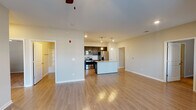 This single-story residence on Bridgewater Drive in Clarksville, Tennessee offers a well-designed open-concept layout that seamlessly connects the living, dining, and kitchen areas. Hardwood-style flooring flows throughout the main living spaces, complemented by neutral-toned walls and ceiling fans that enhance comfort and airflow.

The kitchen is a standout feature, showcasing dark espresso cabinetry, granite countertops, a white subway tile backsplash, and a full suite of stainless steel appliances including a range, microwave, dishwasher, and refrigerator. A central island with a granite surface and pendant lighting above adds both workspace and visual appeal.

The living area benefits from multiple windows that admit generous natural light, creating a bright and welcoming atmosphere. Bedrooms are finished with plush carpeting, ceiling fans, and windows fitted with blinds for privacy and light control.

The bathrooms are well-appointed, each featuring dark cabinetry with granite countertops, large mirrors, and hardwood-style flooring. One bathroom includes a tiled soaking tub and shower combination, while another provides a similar tub-shower setup, both finished with brushed nickel hardware throughout.