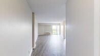 Located in Memphis, TN 38104, this one-bedroom, one-bathroom unit is thoughtfully laid out across a single floor, offering a functional and comfortable living environment. The open living and dining area is anchored by durable wood-look plank flooring and features large sliding glass doors that flood the space with natural light while providing direct access to a private balcony with outdoor views. A wall-mounted PTAC unit provides convenient climate control. The kitchen is equipped with standard appliances, including a refrigerator and range, and connects seamlessly to the entry and dining areas. The bedroom is finished with plush carpeting and also features sliding glass door access to the balcony, along with its own PTAC unit for individualized comfort. A textured ceiling carries throughout the unit, adding subtle visual character. The bathroom includes a full tub-shower combination with tiled surround, a toilet, and a vanity with sink. Wood-look flooring extends into the bathroom, maintaining a cohesive aesthetic. The unit also benefits from multiple closets distributed throughout, providing generous storage options. Two hallway areas help define transitions between the living spaces, contributing to a well-organized and efficient floor plan.