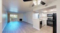 Located at 4610 Fulton Ave in Sherman Oaks, Los Angeles, this 2-bedroom, 2-bathroom single-floor home offers a well-designed open layout that maximizes its comfortable living space. The combined living and kitchen area serves as the heart of the home, featuring light hardwood-style flooring that flows throughout. The living room is highlighted by a classic fireplace, a ceiling fan, and a sliding glass door that opens to a private balcony, filling the space with natural light and outdoor greenery views. The kitchen is outfitted with crisp white cabinetry, light stone countertops, a peninsula with a sink, a tray ceiling with track lighting, and a full suite of black appliances including a gas range, microwave, dishwasher, and refrigerator. The spacious primary bedroom offers a generous footprint, a large window with lush outdoor views, and a mirrored sliding closet door. The second bedroom is well-proportioned with neutral walls and ample natural light. Both bathrooms feature clean white finishes with tub-shower combinations and large vanity mirrors. Throughout the home, neutral tones, clean lines, and consistent flooring create a cohesive and move-in-ready aesthetic.