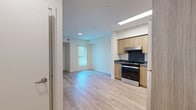 Located at 1642 E Florence Ave in Los Angeles, CA, this efficiently designed one-bedroom, one-bathroom unit offers a thoughtfully laid-out single-floor plan. Light wood laminate flooring runs throughout the entire space, creating a warm, cohesive aesthetic that ties each room together.

The open kitchen is a standout feature, outfitted with light wood cabinetry extending to the ceiling for ample storage, dark countertops, a dark tile backsplash, and a full suite of stainless steel appliances including a refrigerator and electric range. A recessed panel ceiling light brightens the workspace, and the kitchen opens naturally into the living area, maximizing the sense of openness.

The bedroom is a cozy, well-proportioned room featuring crisp white walls and a window fitted with vertical blinds that allow natural light to filter in while providing privacy. The clean, neutral palette makes the room adaptable to a variety of furnishing styles.

The bathroom is clean and functional, with white walls, a full soaking tub with safety grab bars, and light wood flooring that continues the unit's consistent design language. The accessible layout adds practical value to the space.

Overall, this unit presents a modern, move-in-ready interior with a clean, minimalist aesthetic, ideally situated in the Florence neighborhood of Los Angeles.