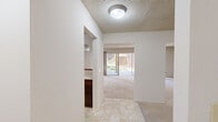 Located at 1059 Wood Duck Ave in Santa Clara, California, this single-story, three-bedroom, two-bathroom home offers a practical and comfortable layout. The combined kitchen and living room serves as the heart of the home, with the kitchen featuring rich dark wood cabinetry, light countertops, tile flooring, and a built-in breakfast bar. The living area flows naturally toward large sliding glass doors that invite natural light and provide views of the outdoor surroundings. A textured ceiling and a baseboard heating unit are consistent throughout the main living spaces. The three bedrooms are carpeted and well-proportioned, with the spacious primary bedroom offering generous room to accommodate various furniture arrangements. Each bedroom benefits from windows that bring in natural light and outdoor views of the surrounding greenery. The two full bathrooms are finished in neutral tones, each featuring a single-sink vanity with ample cabinet storage. One bathroom includes a tub-shower combo with sliding glass doors, while the other offers a standalone shower. A central hallway connects the bedrooms and bathrooms, contributing to an efficient and easy-to-navigate floor plan. Throughout the home, light-toned walls and carpeting create a clean, neutral aesthetic.
