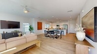 This contemporary 1860 square foot residence in La Quinta, California, offers a harmonious blend of comfort and style. The single-story layout encompasses four bedrooms, including a generous 230 square foot primary suite, and six bathrooms, ensuring ample space and privacy for residents and guests alike.

The heart of the home is a spacious open-concept area combining the kitchen, living room, and dining space. The kitchen boasts sleek white cabinetry, stainless steel appliances, and a functional island, perfect for casual dining or entertaining. Large windows and sliding glass doors flood the living areas with natural light, creating a bright and airy atmosphere.

Each bedroom is thoughtfully designed with neutral tones and modern fixtures, providing serene retreats. The bathrooms feature clean lines, ample storage, and contemporary finishes. A dedicated laundry room adds convenience to daily life.

The exterior of the property showcases drought-resistant landscaping, reflecting the local climate while maintaining aesthetic appeal. A garage provides secure parking and additional storage space.

Throughout the home, light wood flooring and a neutral color palette create a cohesive, modern aesthetic. Ceiling fans and recessed lighting contribute to the overall comfort and ambiance. This well-appointed residence offers a perfect balance of functionality and style in the desirable La Quinta area.