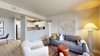 Located at 362 Tanglewood Dr in Richland, WA, this one-bedroom, two-bathroom ground-floor unit offers a thoughtfully designed single-level layout. The open-concept living and dining area flows naturally from the kitchen, which features white shaker cabinetry, stainless steel appliances including a refrigerator, range, and microwave, dark countertops, and a skylight that brightens the space. The adjacent dining area provides an intimate setting with neutral walls.

The living room is comfortably sized, with large windows allowing natural light and a warm, welcoming ambiance. Light wood-style flooring runs throughout the main areas, contributing to a cohesive aesthetic.

A dedicated office with a window and natural light offers a functional workspace. The bedroom accommodates a full-size bed with room to spare, includes a large closet, and features a window with outdoor views. Both bathrooms are finished with white vanity cabinetry, dark countertops, large mirrors, and tub-shower combinations. A hallway connects the private areas of the unit efficiently. The overall design is clean, modern, and well-organized throughout.