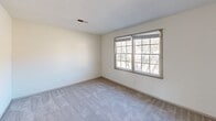 Located at 800 Beatty Rd in Columbia, SC, this two-story home offers three bedrooms and two bathrooms across two well-proportioned floors. The main level features durable wood-look flooring throughout, with neutral white walls and textured ceilings that create a clean, bright atmosphere. The kitchen stands out as a highlight, showcasing gray shaker-style cabinetry, white subway tile backsplash, light quartz-style countertops, a double stainless steel sink, and black and stainless appliances — all centered around a window that brings in natural light. A central staircase connects the two floors. The lower level also includes a hallway that guides flow through the home. Upstairs, the three bedrooms are finished with plush carpeting and feature large windows that fill the rooms with natural light and offer views of surrounding greenery. Each bedroom includes closet storage with double-door closets. The spacious primary bedroom provides a generous retreat. The bathrooms are clean and functional, with one featuring a full shower-tub enclosure. Ceiling fans are present in select rooms, adding to overall comfort. The home presents a practical and well-maintained layout suited for everyday living.