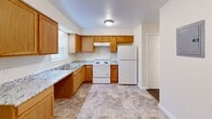 Located at 1523 E Grand Blvd in St. Louis, Missouri, this single-floor, 2-bedroom, 2-bathroom unit offers a straightforward and functional layout designed for comfortable everyday living. The kitchen is well-appointed with warm honey-toned wood cabinetry, granite-look countertops, a double sink, white appliances including an electric range and refrigerator, and tile flooring that extends into the adjacent dining area. Natural light enters through a window, keeping the space bright and practical. Both bedrooms are finished with soft wall-to-wall carpeting and neutral cream-toned walls that create a clean, understated atmosphere. The primary bedroom is a comfortable size and includes a sliding double-door closet along with a window overlooking the outdoors. The second bedroom is well-proportioned and equally inviting. The two bathrooms are finished with stone-look tile flooring and white fixtures, including a full tub-shower combination in one and a half bath configuration in the other. Throughout the unit, consistent neutral tones, white trim, and panel-style doors create a cohesive and tidy aesthetic. Two hallways connect the rooms efficiently, completing this well-organized and move-in ready home.